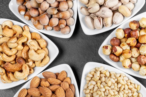 a selection of bowls of nuts laid out in a star shape a selection of bowls of nuts laid out in a star shape