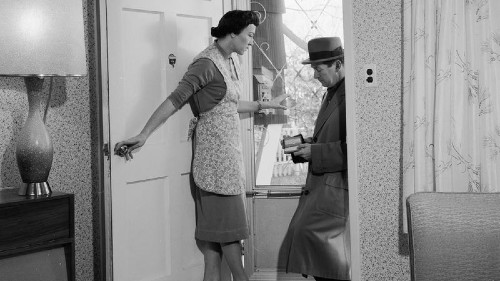 black and white picture of a salesman at a womans door in the 40s