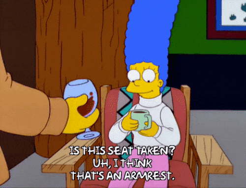 the simpsons cartoon margis is sitting while another character obtrusively sits on her arm rest asking if 'this seat is taken', marge responds with I think that's an armrest